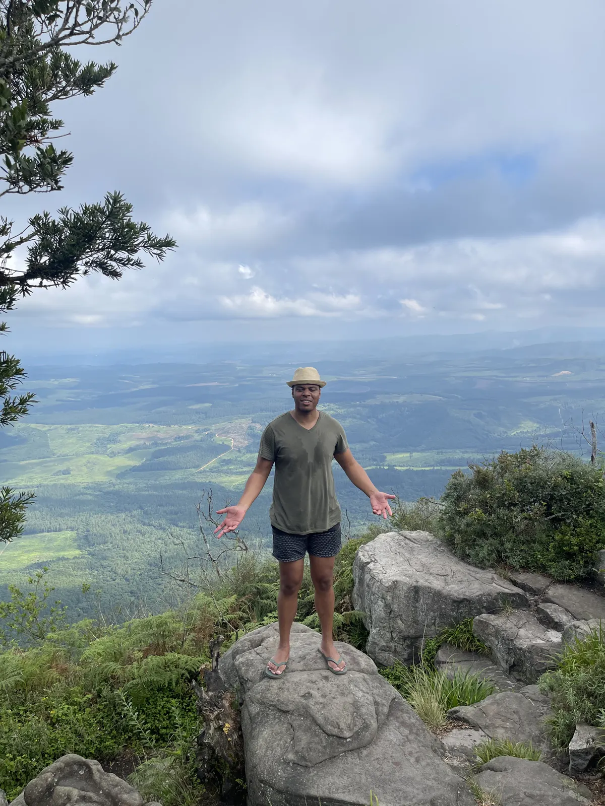 Neil on a rocky summit above a valley